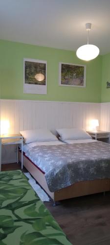 a bedroom with two beds and two tables at Noclegi - Przy Porcie in Łeba