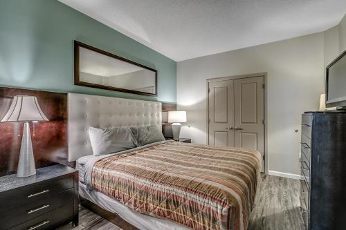a bedroom with a bed and a mirror on the wall at Newly Renovated Ocean Front Condo, Modern Decor, Central MB, 20th floor in Myrtle Beach
