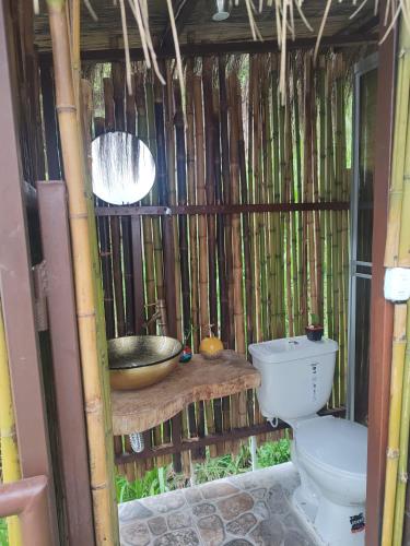 a bathroom with a toilet and a sink at Glamping Mirador de Tibacuy in El Cape