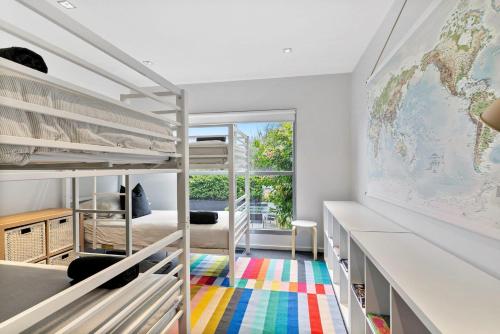 a room with bunk beds with a map on the wall at Azure in Lorne