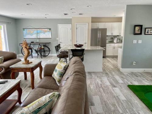 a living room with a couch and a kitchen at Gulf to Golf. in Bradenton