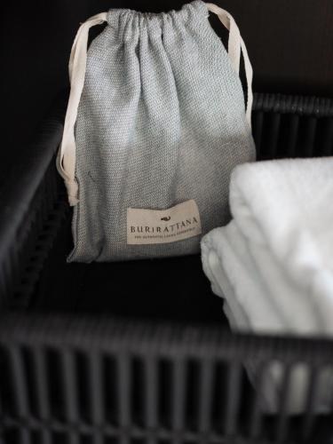 a gray purse sitting on a shelf next to a radiator at Burirattana Hotel-An Adults Only Hotel in Chiang Mai