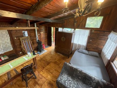 Zimmer mit einem Bett und einem Schreibtisch in einer Hütte in der Unterkunft La Bromelia/Cabaña de Montaña, Cerro de la Muerte. in Cartago