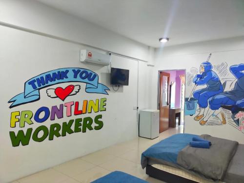 a room with a sign that says thank you frontline workers at ANTZ Village Studio in Kampar