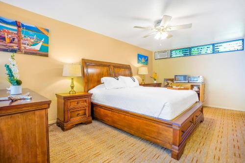 a bedroom with a bed and a ceiling fan at Hale Moi #103B in Princeville
