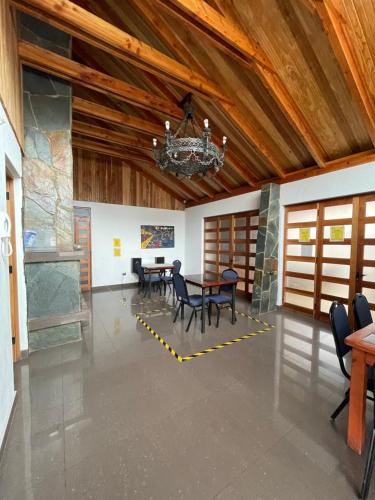 a dining room with a table and chairs and a chandelier at Residencial Astorga in Rancagua