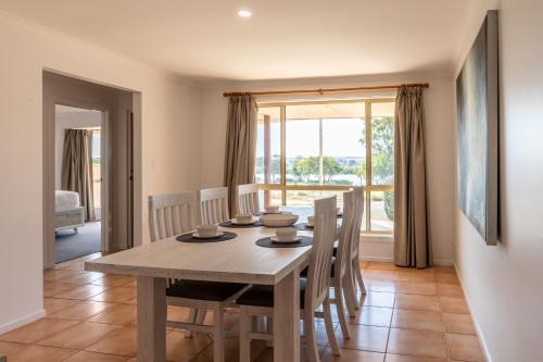 a dining room with a table and chairs at 4 Pelican Court, Woodlane Mypolonga. in Mannum