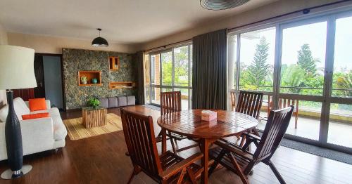 a living room with a wooden table and chairs at Ananas Beach Hotel in Vung Tau