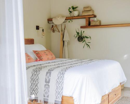 a bedroom with a bed with a white bedspread at Jati Kuta Lombok in Kuta Lombok