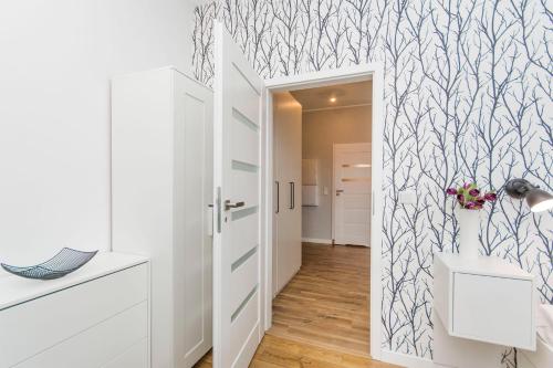 a room with a hallway with a wall mural at Grey Rentyear Apartments in Gdańsk