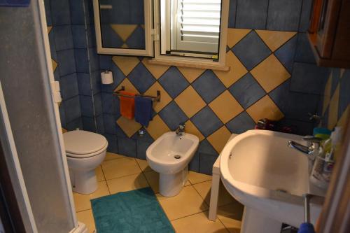 a bathroom with a toilet and a bidet and a sink at Pretty Damuso Style Villa in Lampedusa