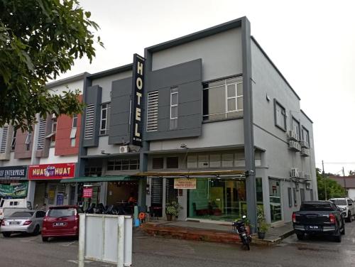 a building on a street with cars parked in a parking lot at D LAYARAN KUANTAN LPT Exit 833 in Kuantan