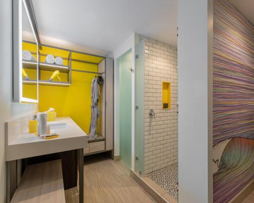 a bathroom with a sink and a shower at Hyatt Centric San Salvador in San Salvador