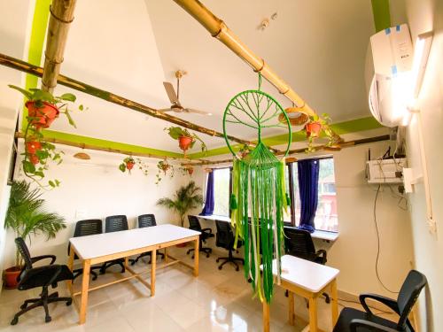 an office with tables and chairs and plants at NomadGao Vila Nova - Comfort, Great Views, Fast WiFi & Interesting People in Anjuna