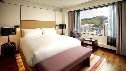a hotel room with two beds and a television at Lotte Hotel Seoul in Seoul
