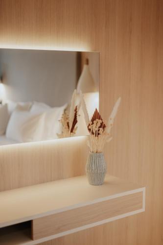 a vase sitting on a shelf in a bedroom at Somnus Suites Parga in Parga