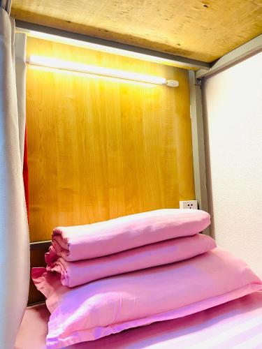 four pink towels stacked on top of each other in a room at Gobi-Girl in Ulaanbaatar