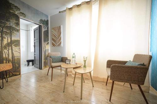 a living room with two chairs and a table at Chambres d'hôtes La Mascrabiere BED & SPA in Albi