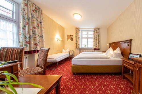 A bed or beds in a room at Brauerei-Gasthof Hotel Post