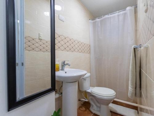 een badkamer met een toilet, een wastafel en een douche bij Room in Guest room - Nice 1br-1bt With Common Picuzzi in Sosúa