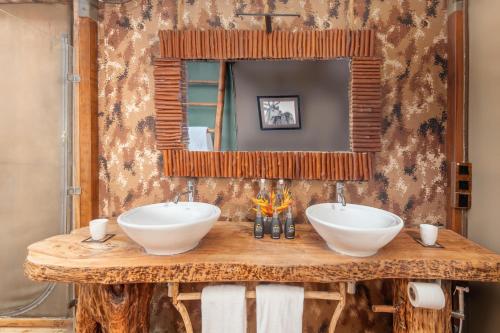 two sinks on a wooden table with a mirror at Leopard Safaris Yala in Yala