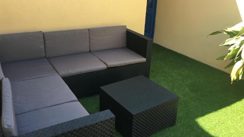 a living room with a couch and a stool at Cal Sabater in Preixana