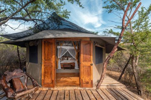 a small tent with a bed in a forest at Leopard Safaris Yala in Yala