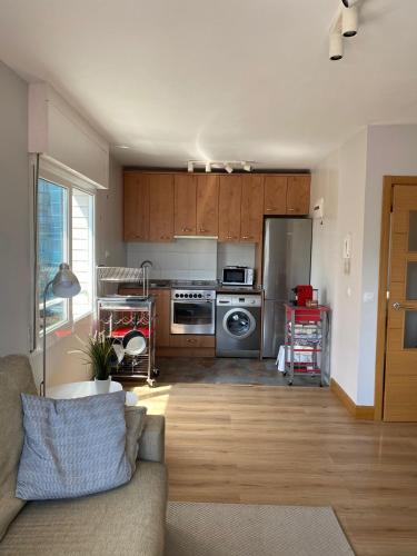 a living room with a kitchen with a couch at Mundaka Best Views House in Mundaka