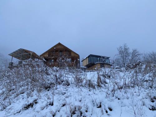 a house on top of a snow covered hill at Mountain House Chirdili in Chirdili