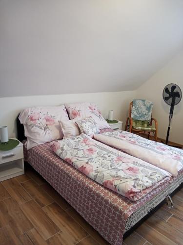 a bed in a room with avertisement for at Borostyán Vendégház in Balatonkeresztúr