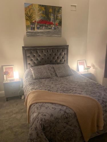 a bed in a bedroom with two lights on at 1 bedroom spacious apartment in Lytham St Annes