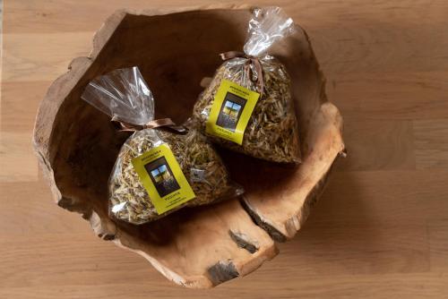 two bags of food sitting on a wooden table at Piešupīte in Staburags