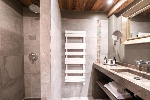 a bathroom with a sink and a toilet and a shower at Chalet-Hôtel Hermitage in Chamonix-Mont-Blanc