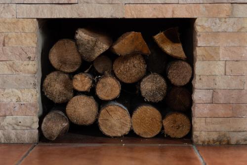 a pile of logs in a brick fireplace at Piešupīte in Staburags