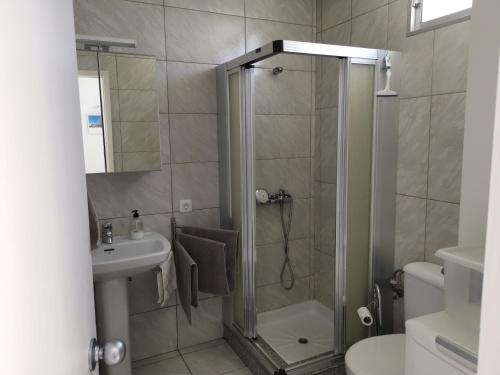 a bathroom with a shower and a sink at Seaside bungalow in Maspalomas