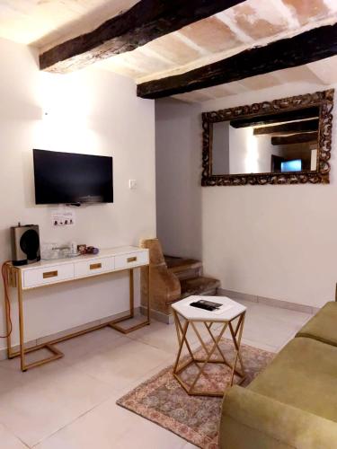 a living room with a couch and a tv on the wall at Casa Birmula Boutique Hotel in Cospicua