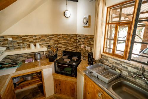 a kitchen with a stove and a sink at Eden Estates and Lodge in Lilongwe