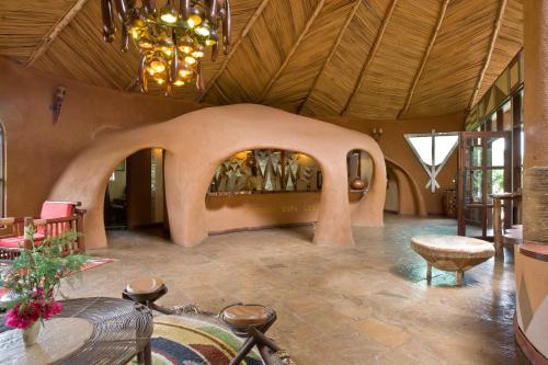 a large room with a large ceiling with a chandelier at Amboseli Sopa Lodge in Amboseli