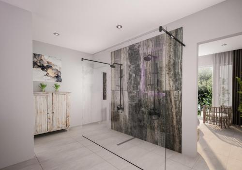 a bathroom with a shower with a wooden wall at BLACK AMBER BOUTIQUE HOTEL in Lampi