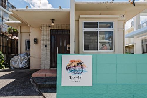 a house with a sign in front of it at Frank's CHATAN in Chatan