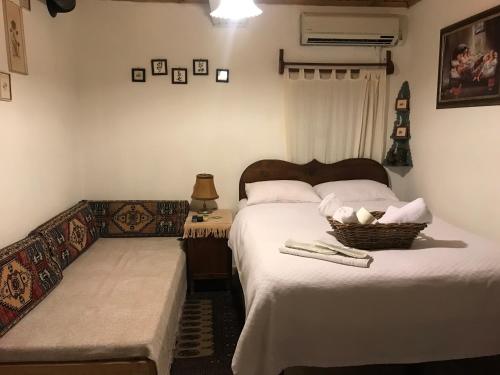 ein Schlafzimmer mit einem Bett und einem Korb mit Handtüchern in der Unterkunft MEGLEN KONAK in Sirince