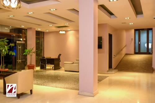 a lobby with a column and a couch and a table at Ngong Hills Hotel in Nairobi