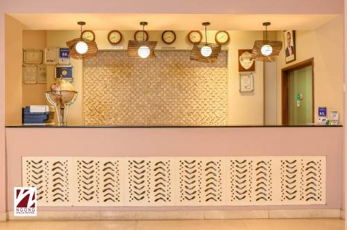 a restaurant with a counter with a mirror at Ngong Hills Hotel in Nairobi