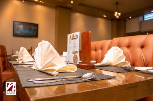 a table with napkins and utensils on top at Ngong Hills Hotel in Nairobi
