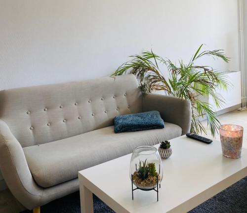 a living room with a couch and a coffee table at KASA VOYTIER Parking privé & Wifi - Balcon & Ascenseur in Saint Etienne