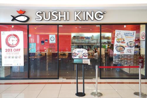 a sushi king store with a sign in the window at ITCC Manhattan Suites by Calvin in Donggongon