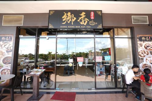 a restaurant with a sign on the front of it at ITCC Manhattan Suites by Calvin in Donggongon