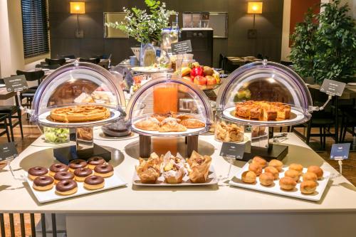 a buffet of pastries and pastries on a table at Living Hotel Milano in Cornaredo