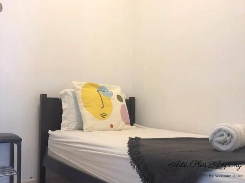a bedroom with a bed with a pillow on it at Arte Plus Jalan Ampang KLCC in Kuala Lumpur