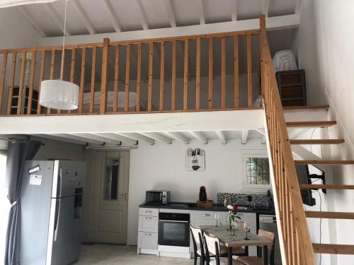 Il comprend une cuisine avec une mezzanine et une table. dans l'établissement Gîte la Lezardière accès privé canal du midi **, à Castelnaudary